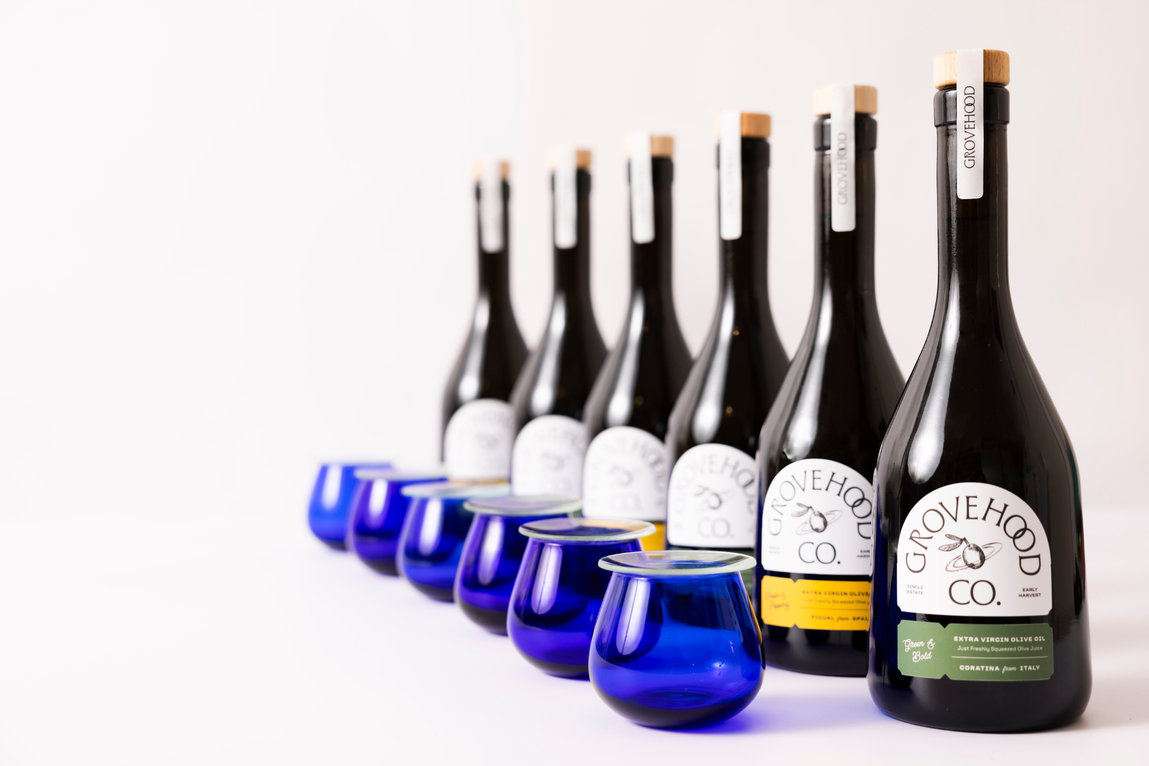 Grovehood Collective Extra Virgin Olive Oil bottles with tasting glasses