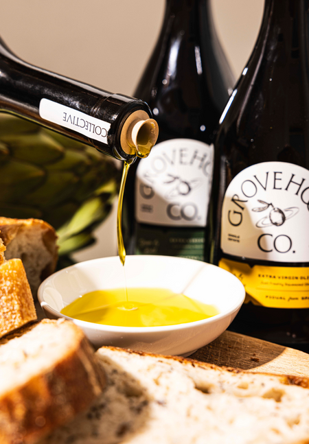 Grovehood Collective Extra Virgin Olive Oil bottles being poured