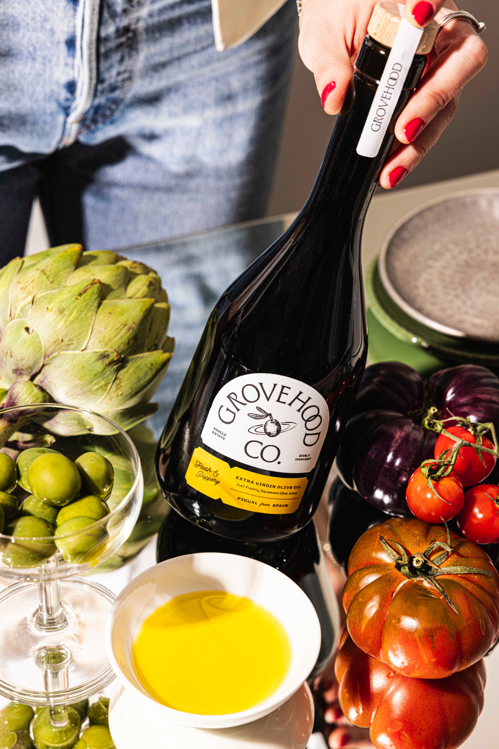 Grovehood Collective Extra Virgin Olive Oil bottle from Spain at a dinner table