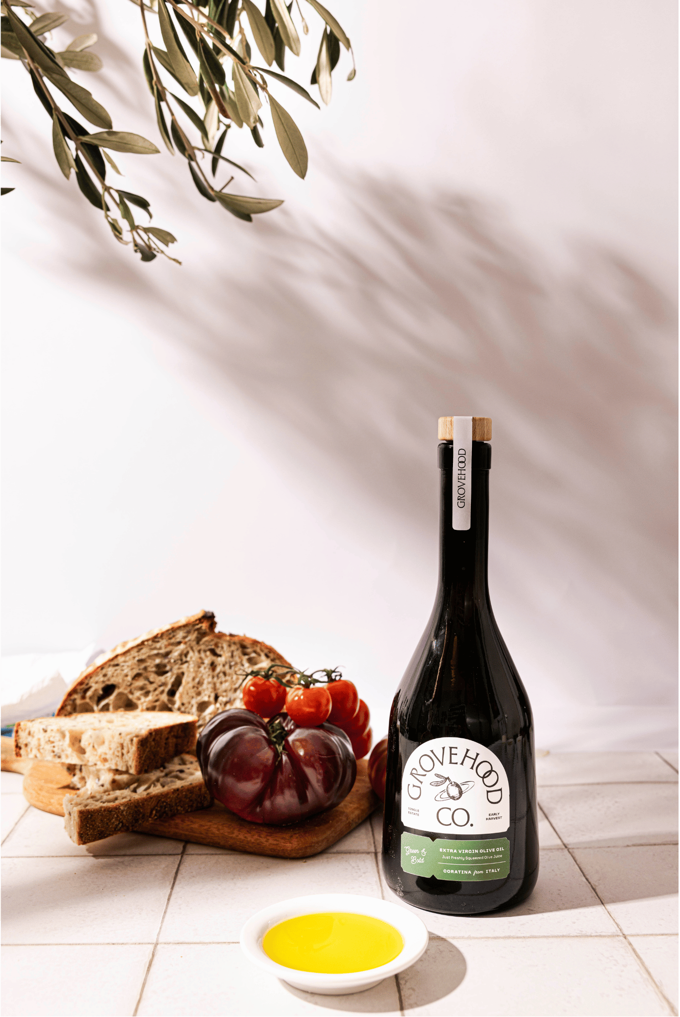 Grovehood Collective Italian extra virgin olive oil bottle with bread and tomatoes